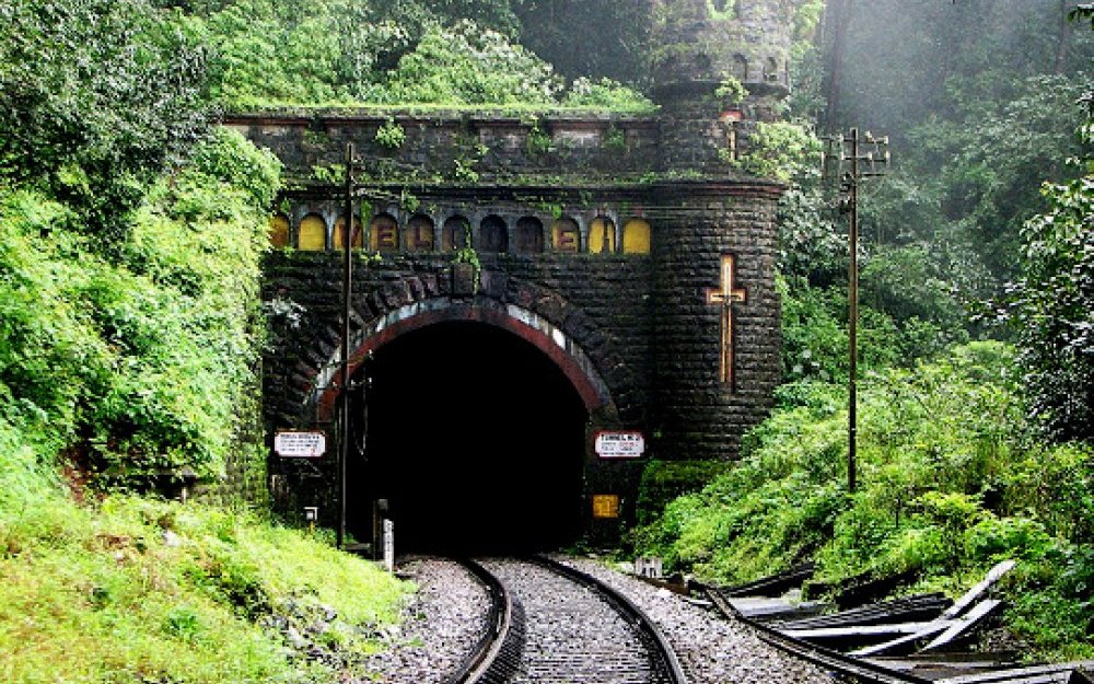 The tunnel portal at Castle Rock station, with its colonial-era stone turret and cross, where the Braganza Ghats descent begins